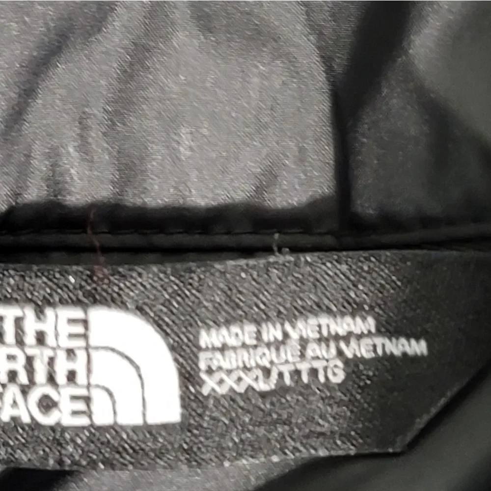 Premium insulated puffer vest by The North Face featuring embroidered Synchrony